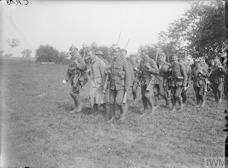 A group of soldiers marching in a field Description automatically generated